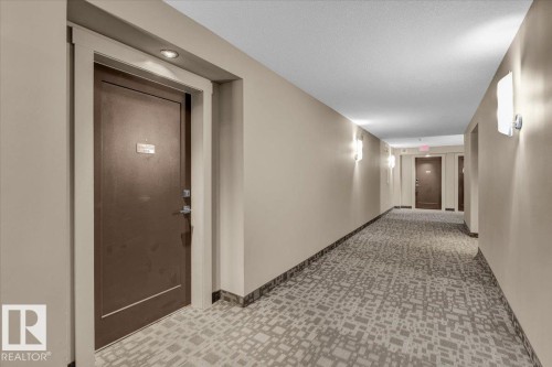 Hall with a textured ceiling and tile patterned floors - 305 5029 Edgemont Boulevard, Edmonton, AB - Indoor Photo Showing Other Room