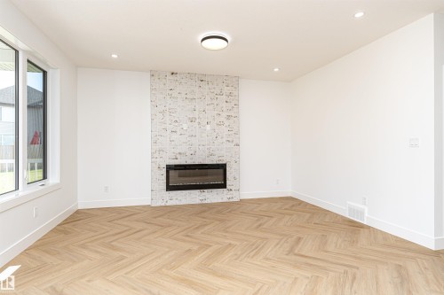 3221 Pelerin Crescent, Beaumont, AB - Indoor Photo Showing Living Room With Fireplace
