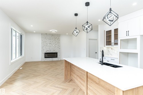 3221 Pelerin Crescent, Beaumont, AB - Indoor Photo Showing Kitchen With Fireplace