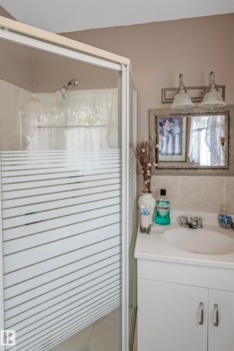 Bathroom featuring vanity, a stall shower, and tile walls - 218 58532 Range Road 113, Rural St. Paul County, AB - Indoor Photo Showing Bathroom