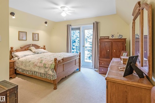 Up stairs loft bedroom, Carpeted bedroom with lofted ceiling, a ceiling fan, and access to outside - 218 58532 Range Road 113, Rural St. Paul County, AB - Indoor Photo Showing Bedroom