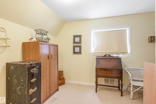 Home office with vaulted ceiling and light colored carpet - 218 58532 Range Road 113, Rural St. Paul County, AB - Indoor