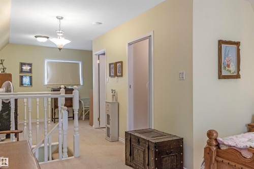 Hall with light carpet and an upstairs landing - 218 58532 Range Road 113, Rural St. Paul County, AB - Indoor