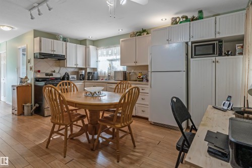 Dining space featuring track lighting, light wood-style flooring, a ceiling fan, and recessed lighting - 218 58532 Range Road 113, Rural St. Paul County, AB - Indoor