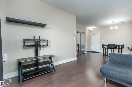 140 6079 Maynard Way, Edmonton, AB - Indoor Photo Showing Living Room