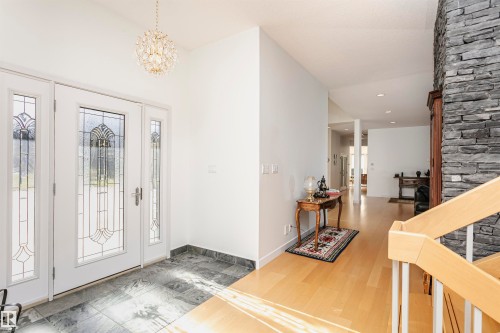 Foyer featuring a chandelier, wood finished floors, and stairway - 19103 Ellerslie Road Sw, Edmonton, AB - Indoor Photo Showing Other Room