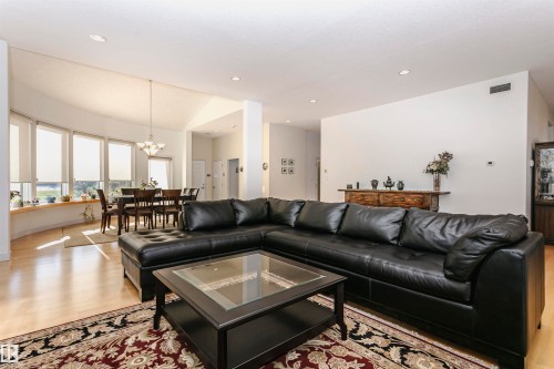 Living room featuring light wood finished floors, recessed lighting, and a chandelier - 19103 Ellerslie Road Sw, Edmonton, AB - Indoor Photo Showing Living Room