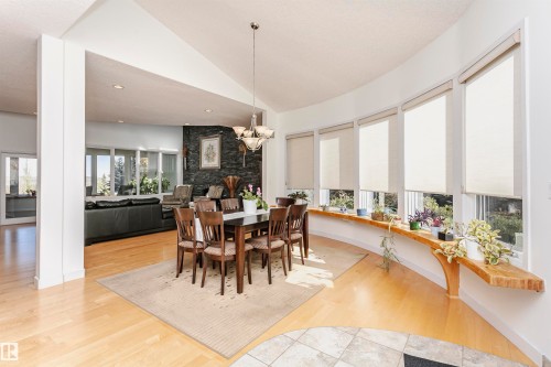 Dining room featuring lofted ceiling, light wood finished floors, recessed lighting, and a chandelier - 19103 Ellerslie Road Sw, Edmonton, AB - Indoor Photo Showing Dining Room