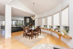 Dining room featuring lofted ceiling, light wood finished floors, recessed lighting, and a chandelier - 