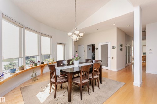 Dining room with light wood-style flooring, vaulted ceiling, recessed lighting, and a chandelier - 19103 Ellerslie Road Sw, Edmonton, AB - Indoor Photo Showing Dining Room