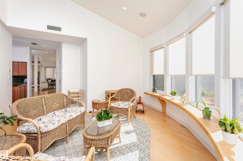 Living area with vaulted ceiling, light wood-style flooring, and recessed lighting - 19103 Ellerslie Road Sw, Edmonton, AB - Indoor Photo Showing Living Room