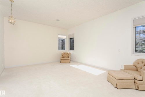 Unfurnished room featuring carpet and a chandelier - 19103 Ellerslie Road Sw, Edmonton, AB - Indoor