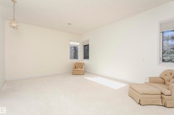 Unfurnished room featuring carpet and a chandelier - 