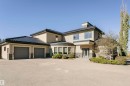 View of front of house featuring stucco siding, a garage, stone siding, and driveway - 19103 Ellerslie Road Sw, Edmonton, AB  - Outdoor 