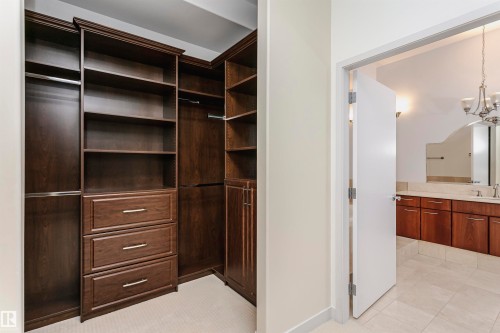 Walk in closet featuring a chandelier and light tile patterned floors - 19103 Ellerslie Road Sw, Edmonton, AB - Indoor