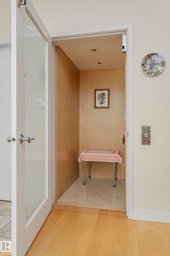 Bathroom with elevator and light wood-style flooring - 19103 Ellerslie Road Sw, Edmonton, AB - Indoor Photo Showing Other Room