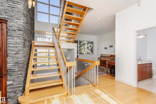 Stairs with wood finished floors and recessed lighting - 19103 Ellerslie Road Sw, Edmonton, AB - Indoor Photo Showing Other Room