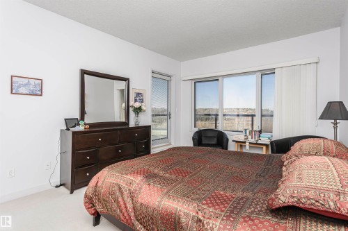 Bedroom with access to outside, carpet floors, and a textured ceiling - 19103 Ellerslie Road Sw, Edmonton, AB - Indoor Photo Showing Bedroom