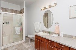 Bathroom with a shower stall and vanity - 