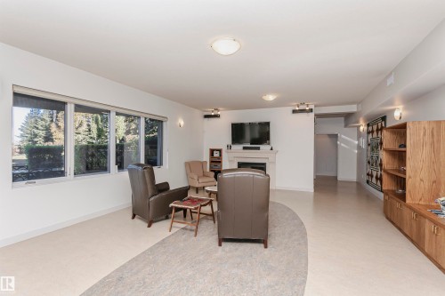 Living room featuring a fireplace and baseboards - 19103 Ellerslie Road Sw, Edmonton, AB - Indoor