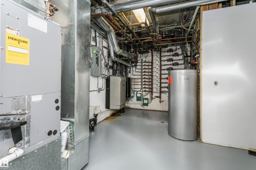 Utilities with heating unit, water heater, electric panel, and a heating unit - 19103 Ellerslie Road Sw, Edmonton, AB - Indoor Photo Showing Basement