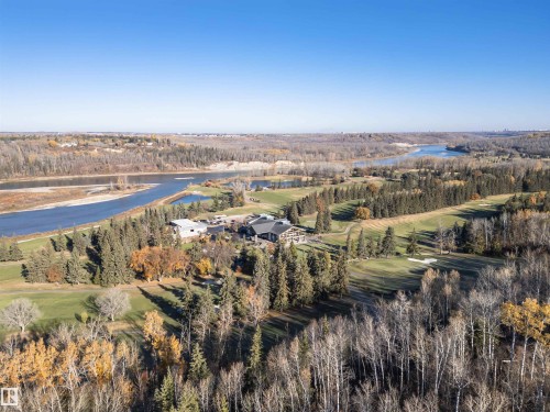 Aerial view of property and surrounding area featuring a nearby body of water and a golf club - 19103 Ellerslie Road Sw, Edmonton, AB - Outdoor With View