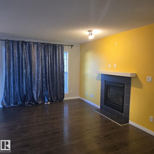 7315 22 Avenue, Edmonton, AB - Indoor Photo Showing Living Room With Fireplace