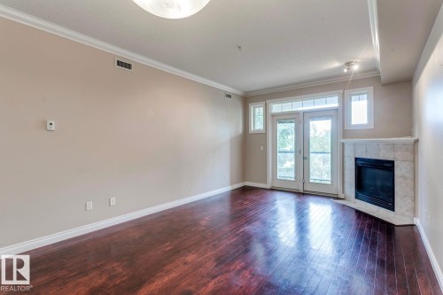 212 12408 15 Avenue, Edmonton, AB - Indoor Photo Showing Other Room With Fireplace