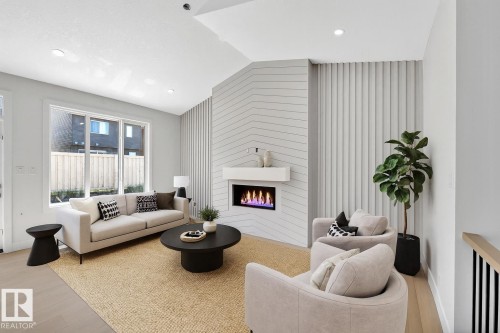24 104 Allard Link, Edmonton, AB - Indoor Photo Showing Living Room With Fireplace