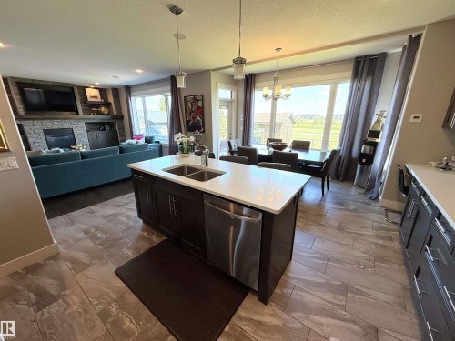 1186 Genesis Lake Boulevard, Stony Plain, AB - Indoor Photo Showing Kitchen With Fireplace With Double Sink