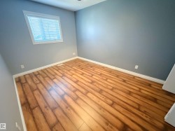Empty room featuring baseboards and wood finished floors - 