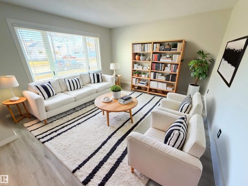 Living area with baseboards and wood finished floors - 10226 152 Street, Edmonton, AB - Indoor Photo Showing Living Room