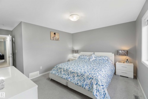 Bedroom featuring light colored carpet and baseboards - 17816 59 Street, Edmonton, AB - Indoor Photo Showing Bedroom