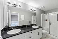Full bathroom featuring double vanity, light tile patterned flooring, a stall shower, ensuite bath, and a textured ceiling - 
