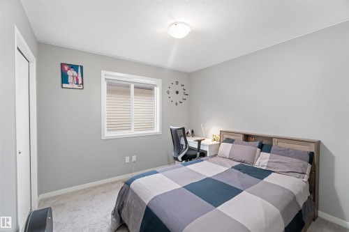 Carpeted bedroom featuring baseboards - 17816 59 Street, Edmonton, AB - Indoor Photo Showing Bedroom