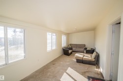 Living area featuring unfinished concrete floors - 