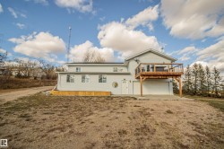 Back of property with driveway, a patio area, and an attached garage - 
