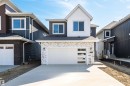View of front of home with board and batten siding, concrete driveway, roof with shingles, and a garage - 3331 Chickadee Drive, Edmonton, AB  - Outdoor With Facade 