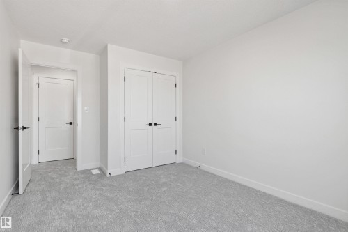 Unfurnished bedroom featuring carpet flooring and a closet - 3331 Chickadee Drive, Edmonton, AB - Indoor Photo Showing Other Room