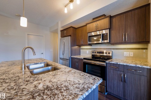 117 10523 123 Street, Edmonton, AB - Indoor Photo Showing Kitchen With Stainless Steel Kitchen With Double Sink With Upgraded Kitchen