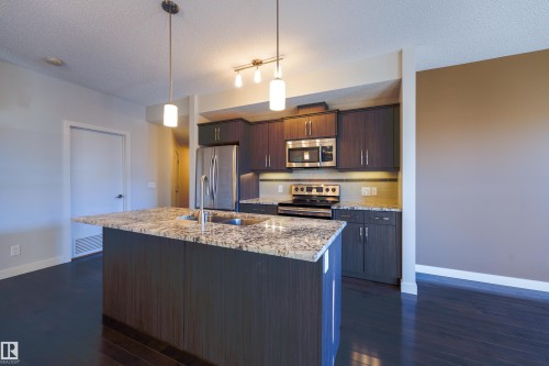 117 10523 123 Street, Edmonton, AB - Indoor Photo Showing Kitchen With Stainless Steel Kitchen With Double Sink With Upgraded Kitchen