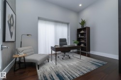 This well-appointed room features dark hardwood floors, light gray walls, and recessed lighting - 
