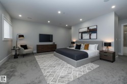 This bedroom features recessed lighting, carpet flooring, a window with blinds, and a door leading to an adjoining room - 