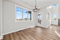 Unfurnished dining area featuring a chandelier and wood finished floors - 