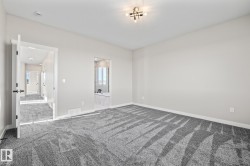 Unfurnished bedroom with carpet and ensuite bathroom - 