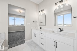 Bathroom with double vanity and light colored carpet - 