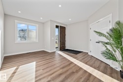 Entryway with wood finished floors and recessed lighting - 