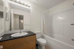 Full bathroom featuring shower / bathtub combination with curtain, a textured ceiling, vanity, and light tile patterned flooring - 