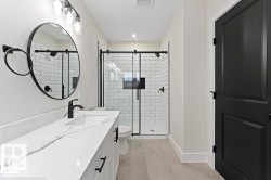 Full bathroom with double vanity, a shower stall, recessed lighting, and light tile patterned flooring - 