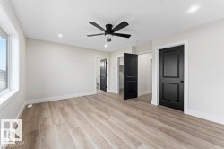 Unfurnished bedroom featuring a spacious closet, light wood-style floors, ceiling fan, and recessed lighting - 